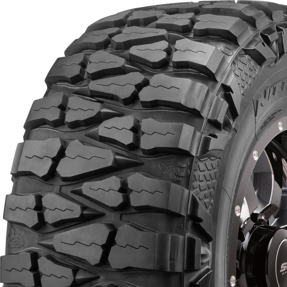 Nitto Mud Grappler extreme terrain tire, deep tread blocks wrapping over the shoulder into lizard-skin sidewall lugs